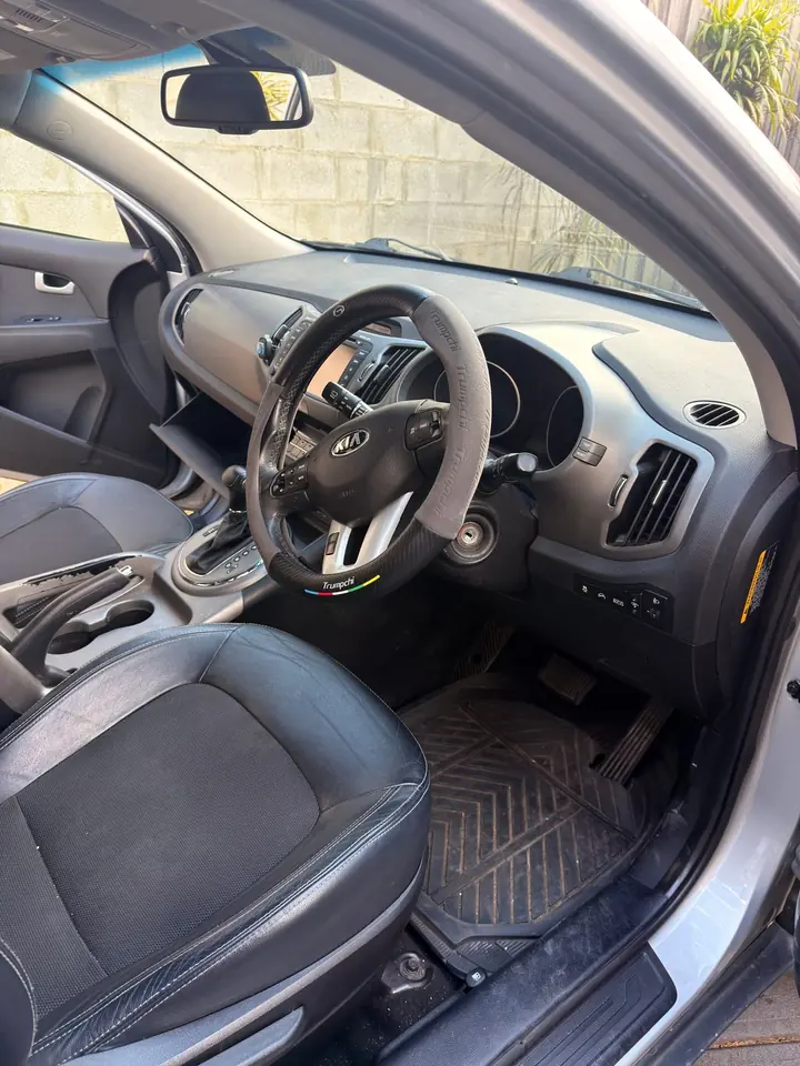 Kia Sportage before: dirty rubber floor mat on the driver side