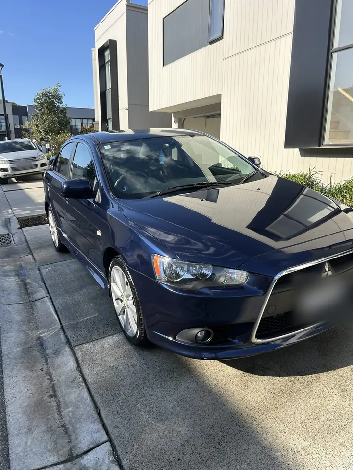 Mitsubishi Lancer after: clean, glossy dark blue paint