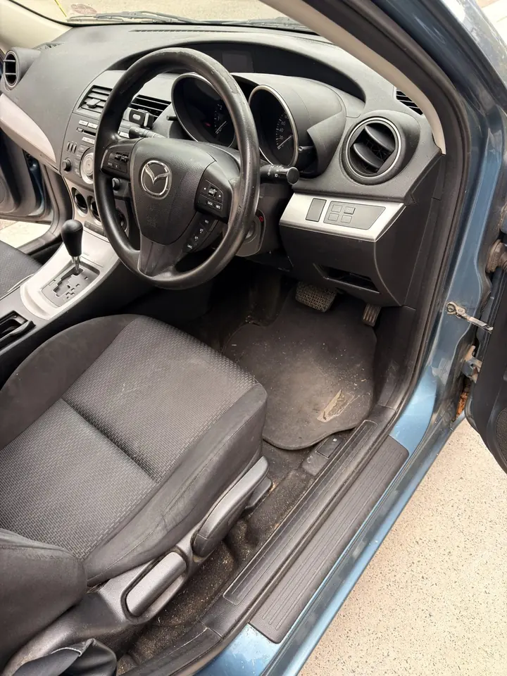 Mazda 3 before: dirty floor mat and door sill